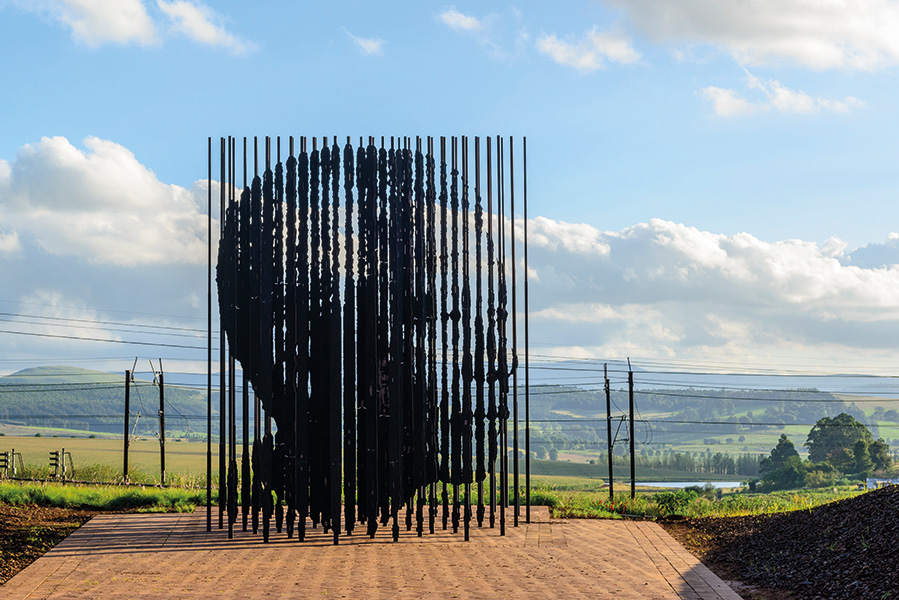 The cluster of columns set at different depths align to create a perfect portrait of Nelson Mandela.