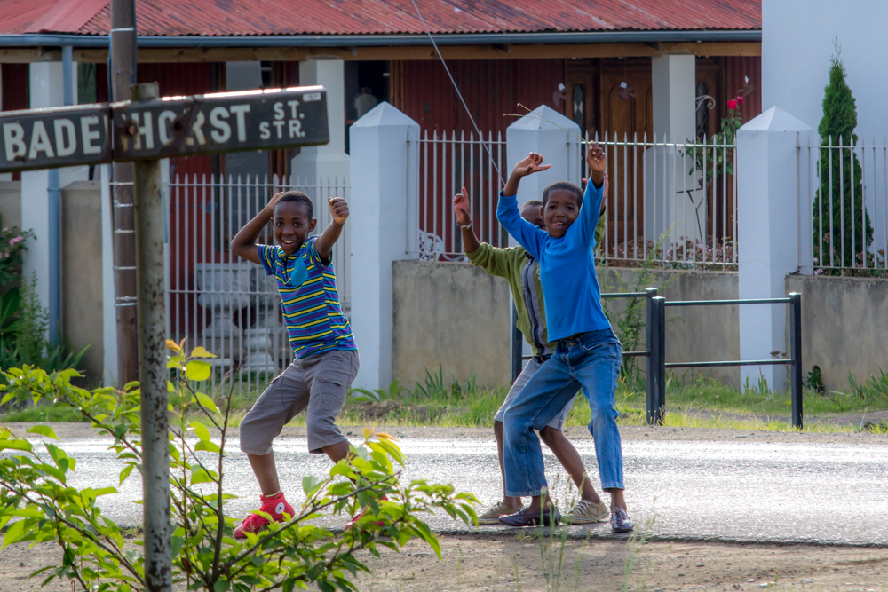 Children dance for the camera in the streets of Wakkerstroom.