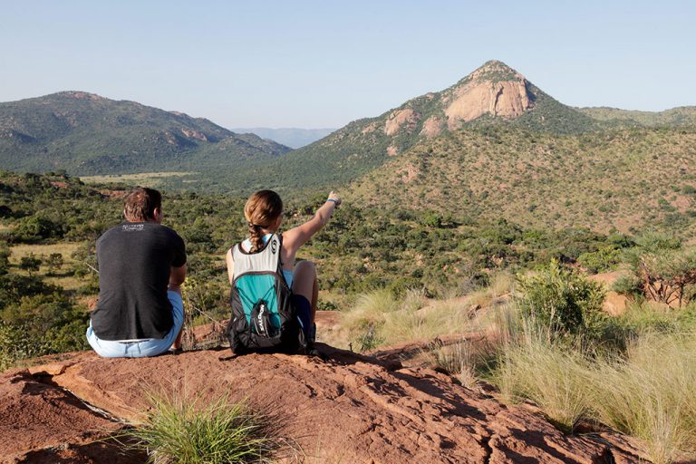 Hikers gaze out at the granite peak of Thabaphaswa from The Lookout. Photo by Shaen Adey