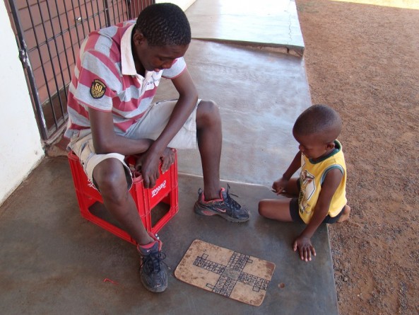 Kids playing ludo outside spaza