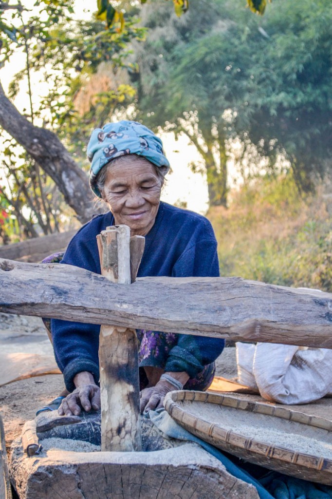 A village lady crushes rice using a see-saw like mechanism. Photo by Melanie van Zyl