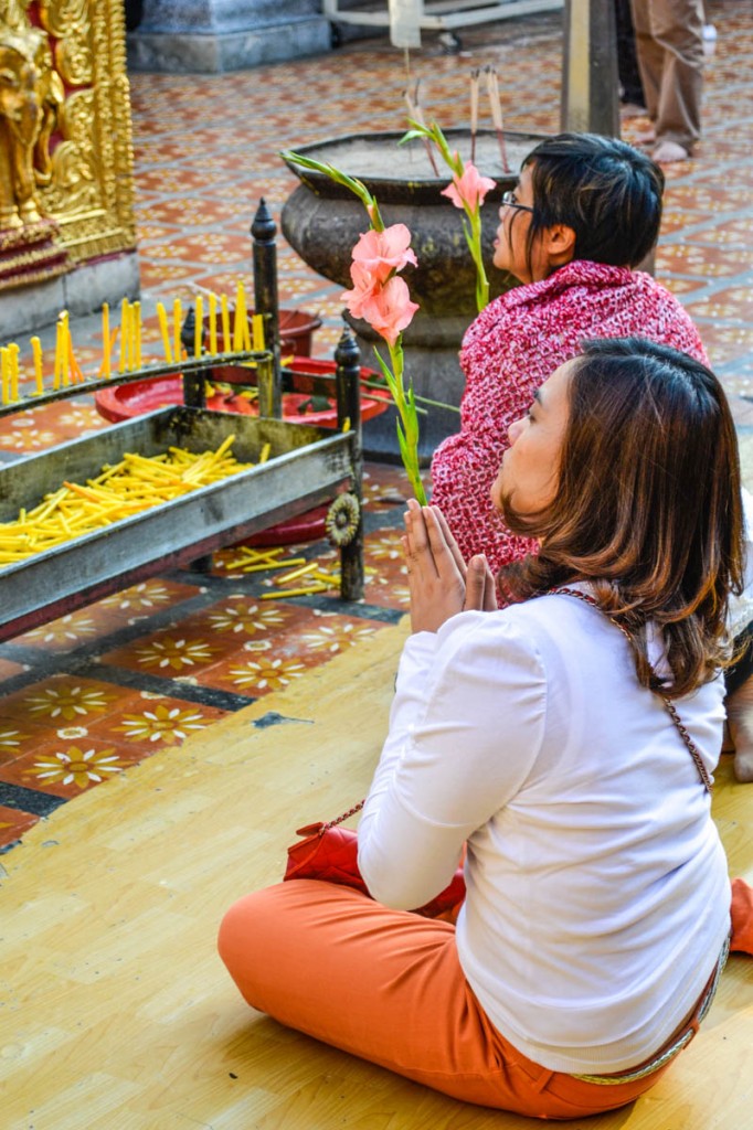 A Thai woman asks for blessings at the temple. Photo by Melanie van Zyl