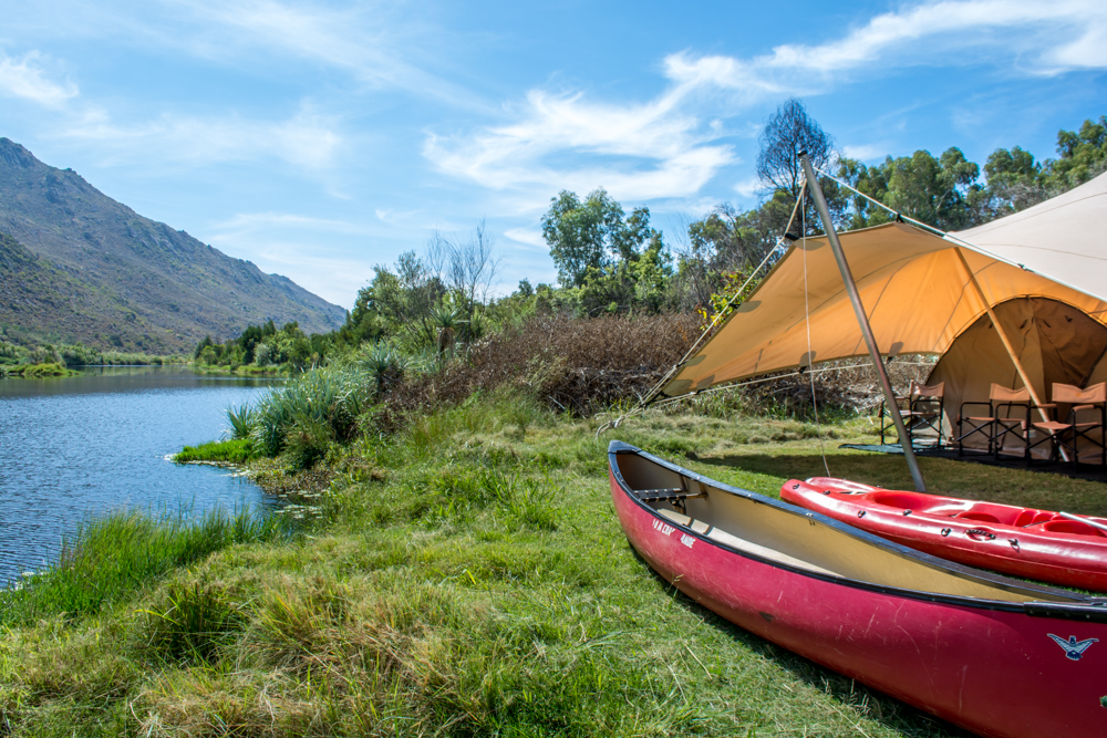 The Wolfkop camping village comes with canoes and a river-side stoep. 