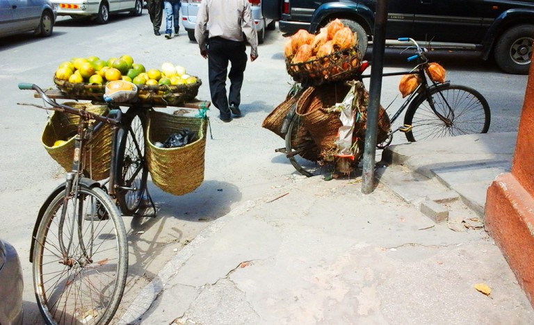A hawkers bicycle carrying peeled and unpeeled oranges.