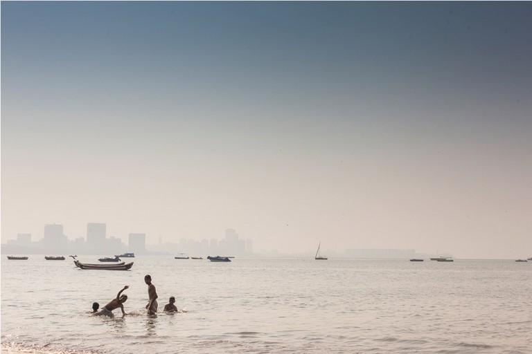 India - Children playing in the waters of Chowpatty beach.