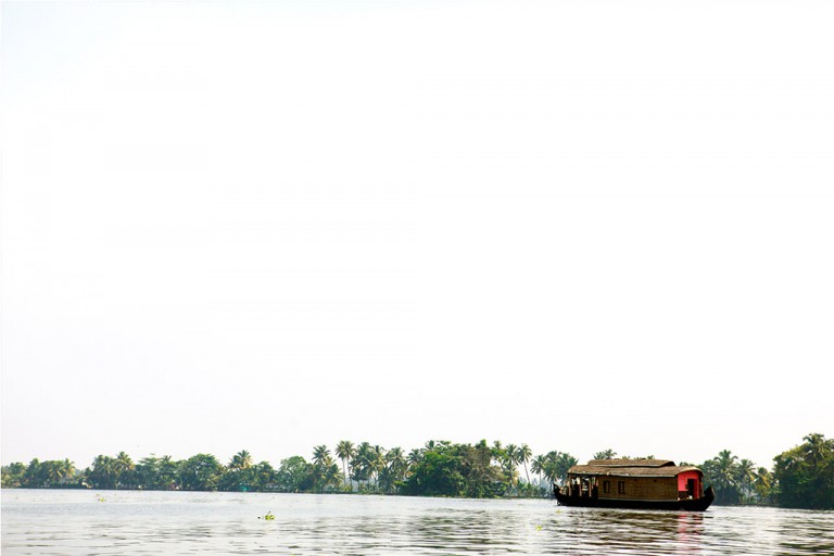 India - Large houseboats cruised circular routes on the canals of Kerela.