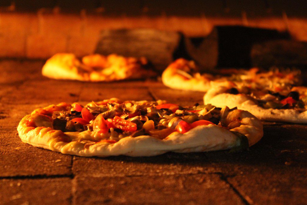 Pizza made from a face brick oven with food fire at 86 Republic. Photo by 86 Republic.