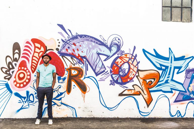 Brandpreneur Matimba Ngwenya outside 8MS' ever-changing graffiti walls.
