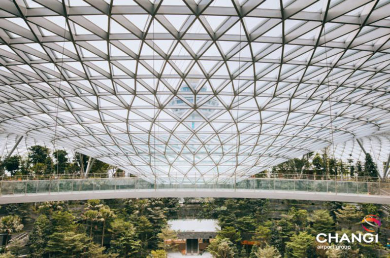The dome is made of 9 600 glass panels. Rain water is funneled into the oculus and is reused in the building for irrigation and cooling. Image: Changi Airport Singapore.