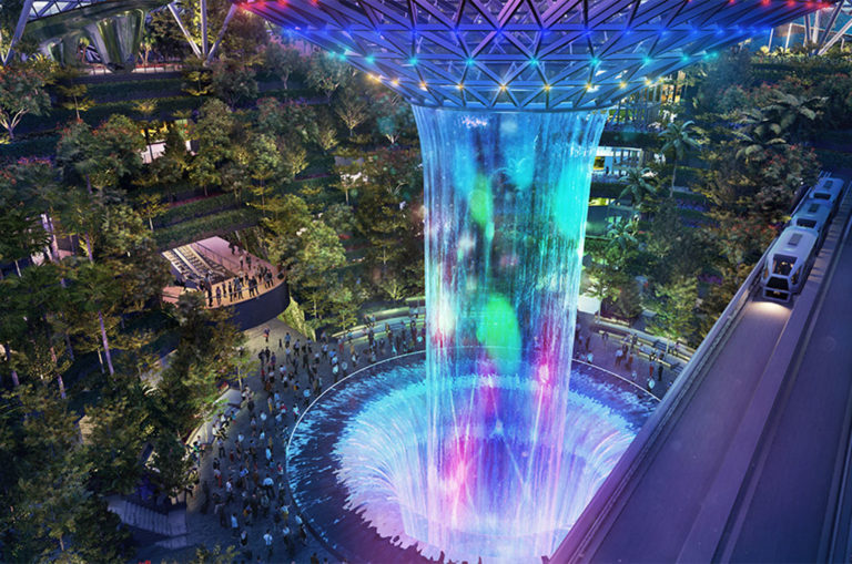 At night, the waterfall becomes a screen onto which a light and sound show is projected. Image: Changi Airport Singapore.