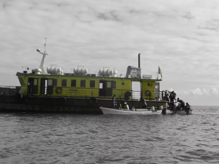 The old ferry can't moor on the island, so smaller boats are used to shuttle passengers to the land. 