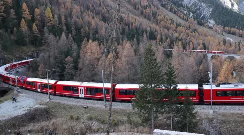 world’s longest passenger train Switzerland, Rhaetian Railway record 2022, Albula Bernina scenic train, Landwasser Viaduct curved bridge, Swiss Alps railway UNESCO, Bergun valley train spectators, narrow gauge Guinness World Record train, Capricorn railcars Switzerland, Alpine railway tunnels and bridges, Swiss mountain train journey, Getaway Magazine