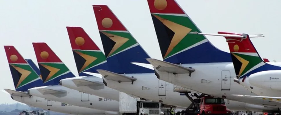 South African Airways aircraft, SAA airplane runway, jet fuel aviation logistics, airline refuelling operations airport, aviation fuel infrastructure South Africa, global aviation fuel supply chains, airport fuel truck aircraft, commercial aviation logistics planning, SAA airline operations aircraft, airline fuel storage tanks airport, aviation industry fuel management, Getaway Magazine
