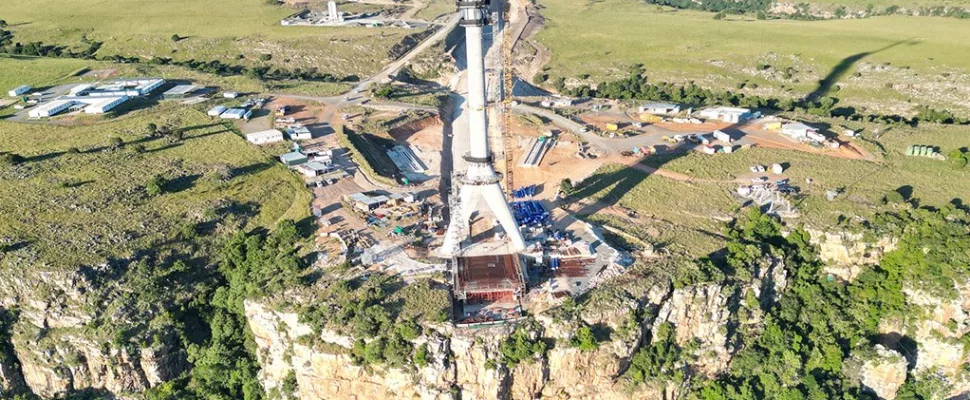 Msikaba Bridge construction Eastern Cape, N2 Wild Coast project South Africa, cable stayed bridge Africa tallest, Msikaba River gorge bridge view, Lusikisiki infrastructure development, SANRAL bridge project progress, Wild Coast road upgrade South Africa, Pondoland travel routes improvement, South Africa steel fabrication challenges, scenic Wild Coast landscape bridge, Getaway Magazine